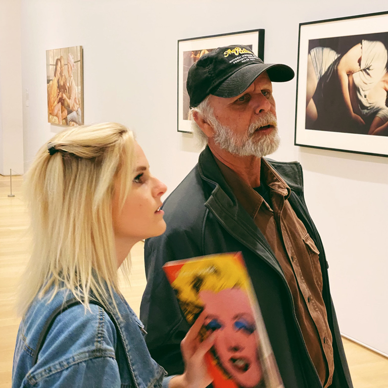 Nikki Pelc looking at contemporary art in a museum.